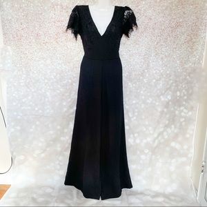 Black flared jumpsuit with mesh cap sleeves